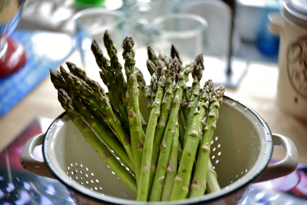 Bunch of green asparagus on a wooden surface